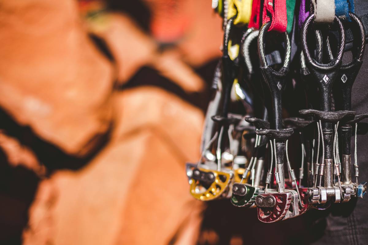 Climber performing Emergency Belay Procedures with assisted-braking belay device on multi-pitch route