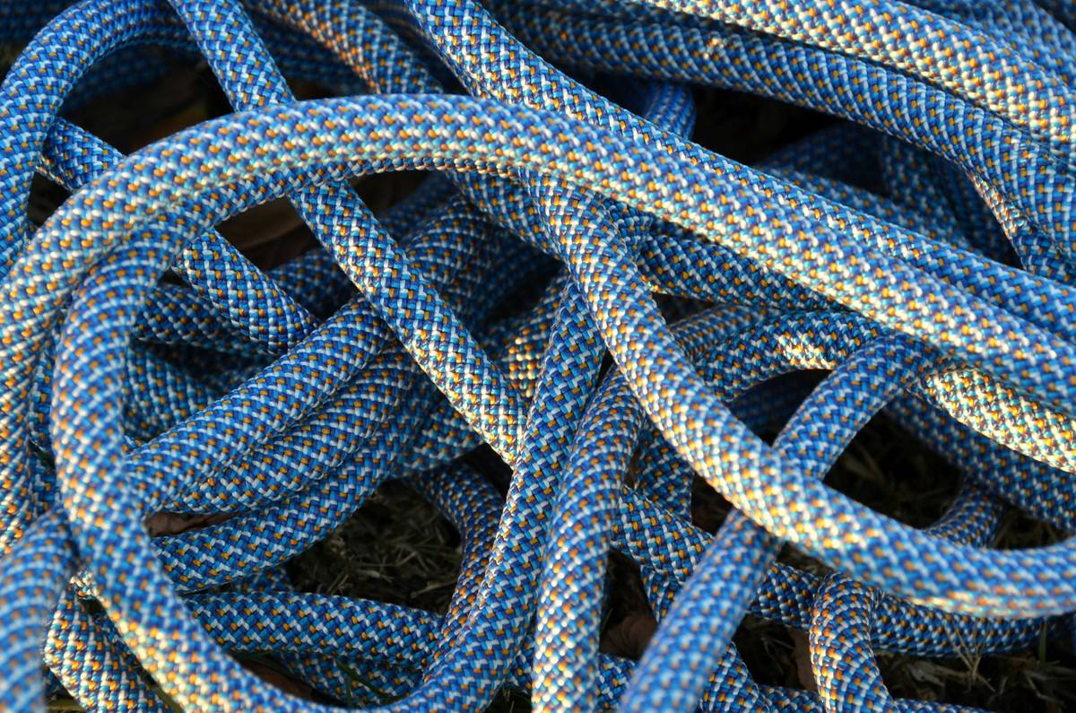 Climber organizing ropes in a dry, shaded area using Rope Storage Solutions
